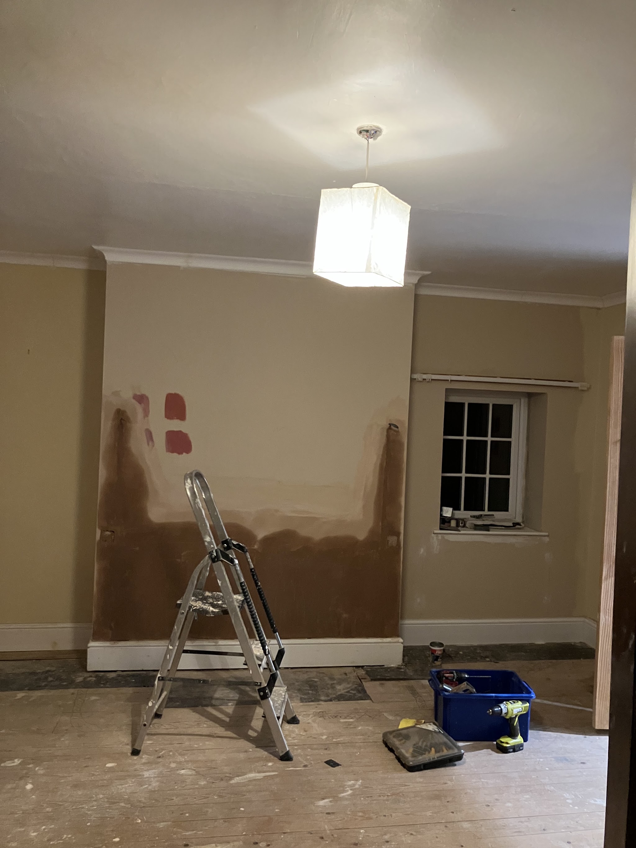 Room mid preparation with filled walls and a stepladder