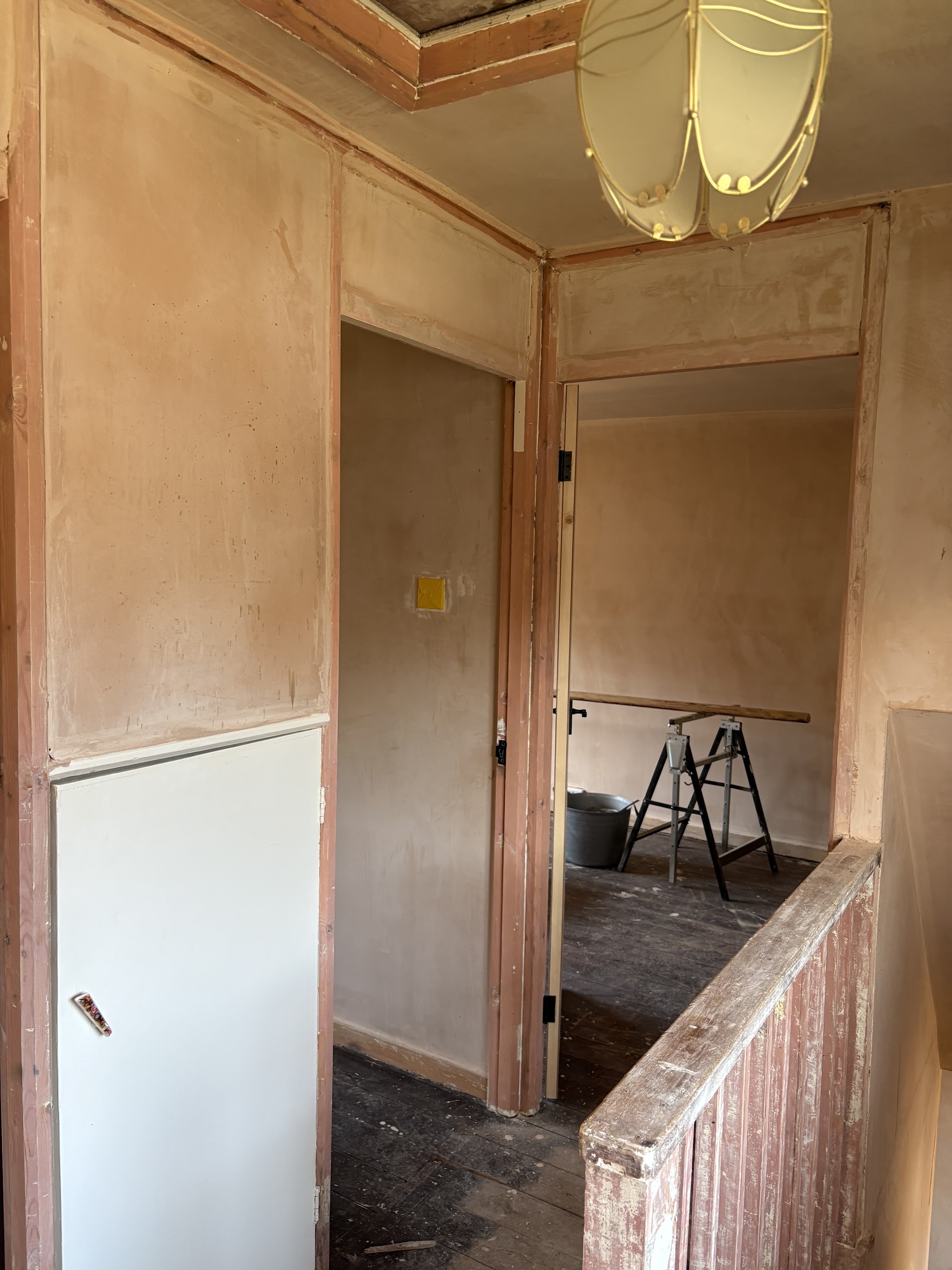 Landing stripped back to bare plaster ready for decorating